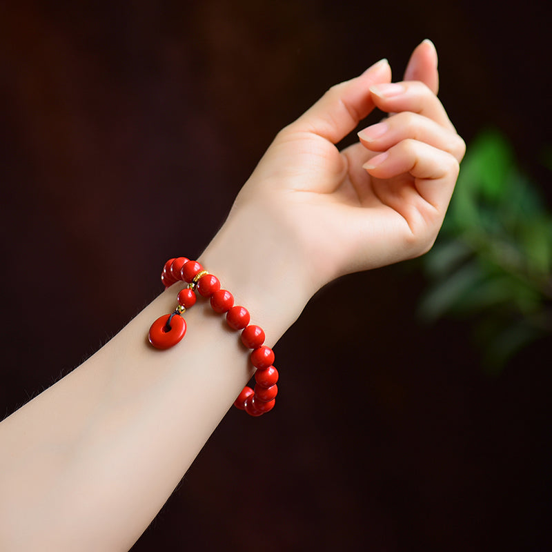 Armband aus Kunstharz in Zinnoberrot mit Obsidian- und Scheibenanhänger 