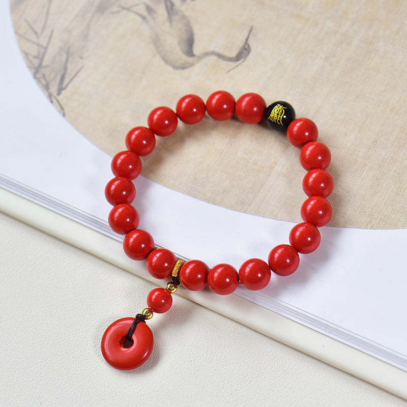 Armband aus Kunstharz in Zinnoberrot mit Obsidian- und Scheibenanhänger 