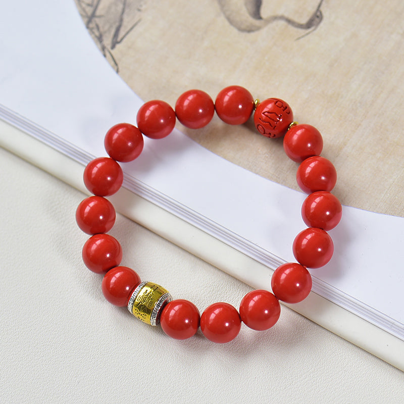 Armband aus Kunstharz in Zinnoberrot mit graviertem Messinganhänger 