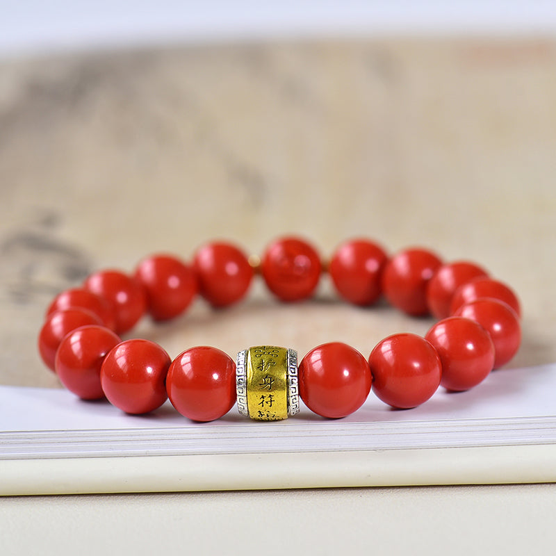 Armband aus Kunstharz in Zinnoberrot mit graviertem Messinganhänger 