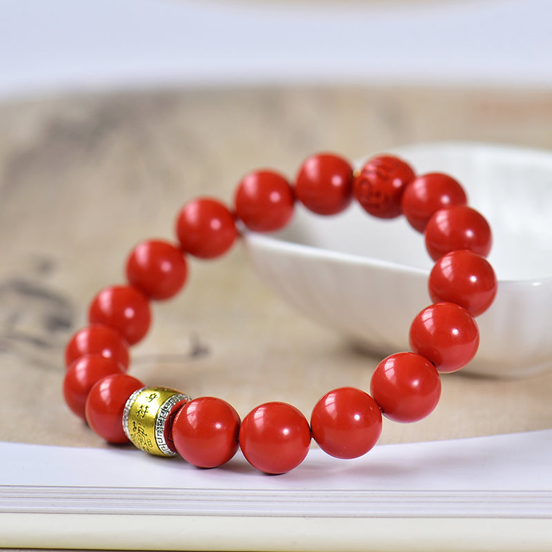 Armband aus Kunstharz in Zinnoberrot mit graviertem Messinganhänger 